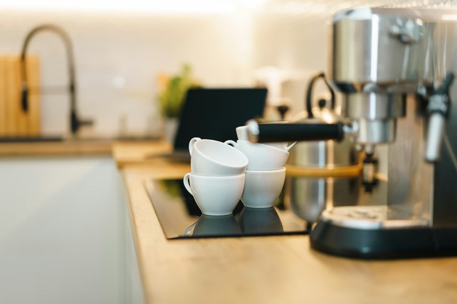Espresso machine and cups in a clean home kitchen